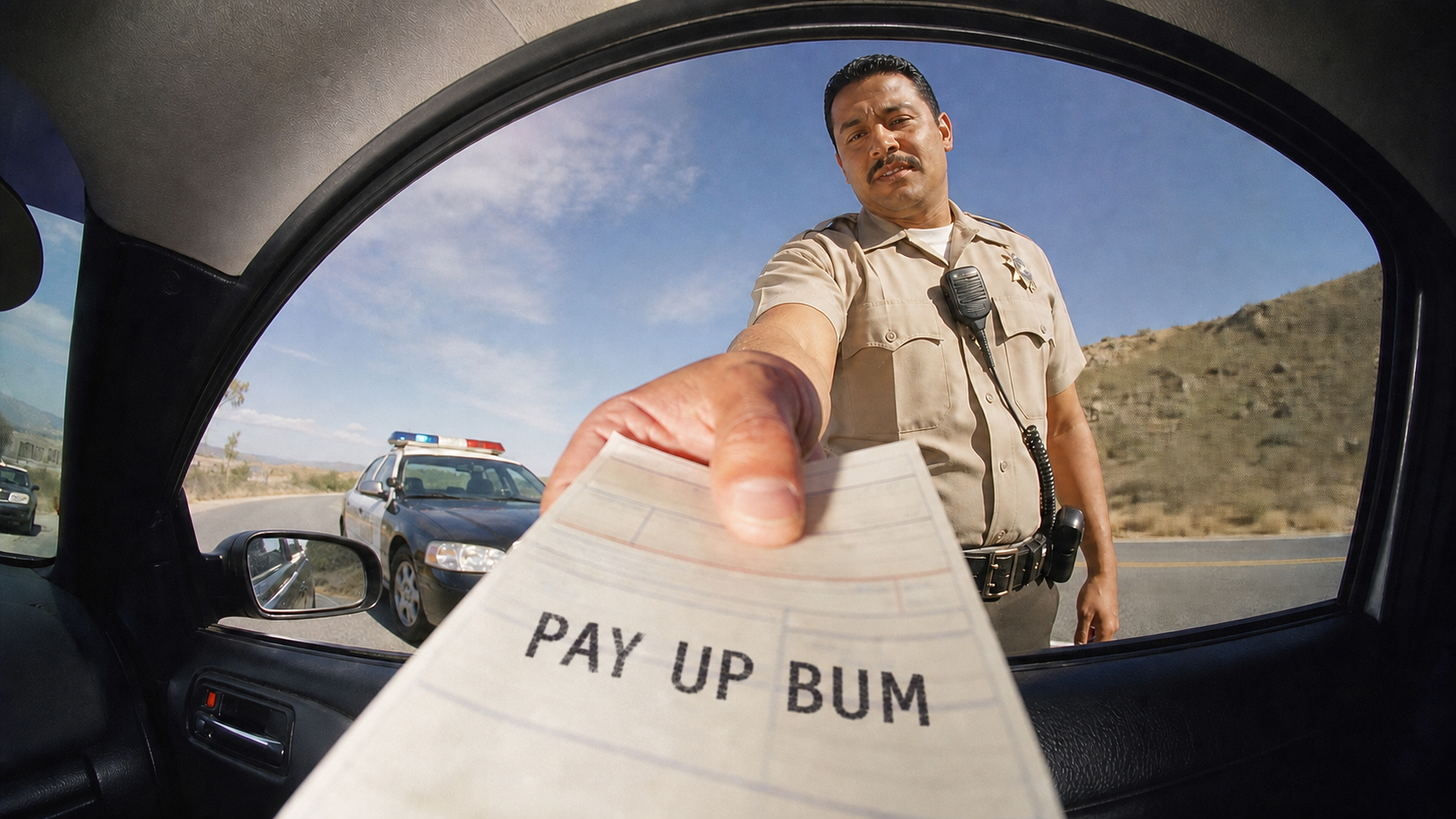 Officer handing over a parking ticket that reads PAY UP BUM